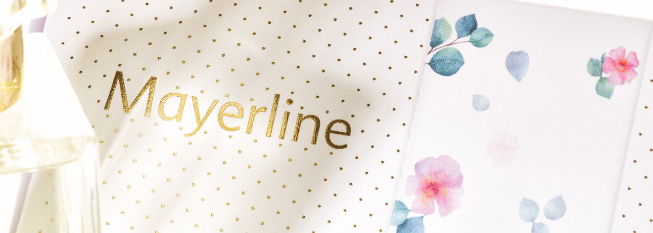 Quatre Mains package design - gold foil, floral pattern, dots, quatre mains